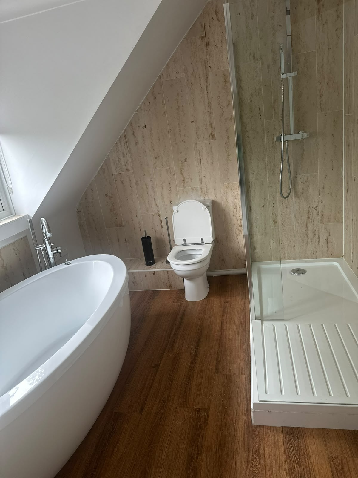 Deep-cleaned bathroom with freestanding bath and shower
